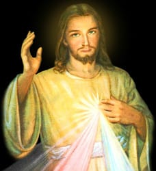 Devotional image of the Divine Mercy: Jesus in a white robe with rays of red and white light emanating from his heart, one hand raised in blessing.
