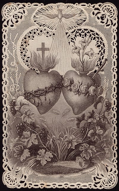 Antique holy card showing two Sacred Hearts with a cross and dove above, surrounded by lace-style floral border, in sepia tones.