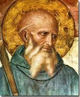 Fresco detail of Saint Benedict of Nursia, bearded, with a golden halo and staff.